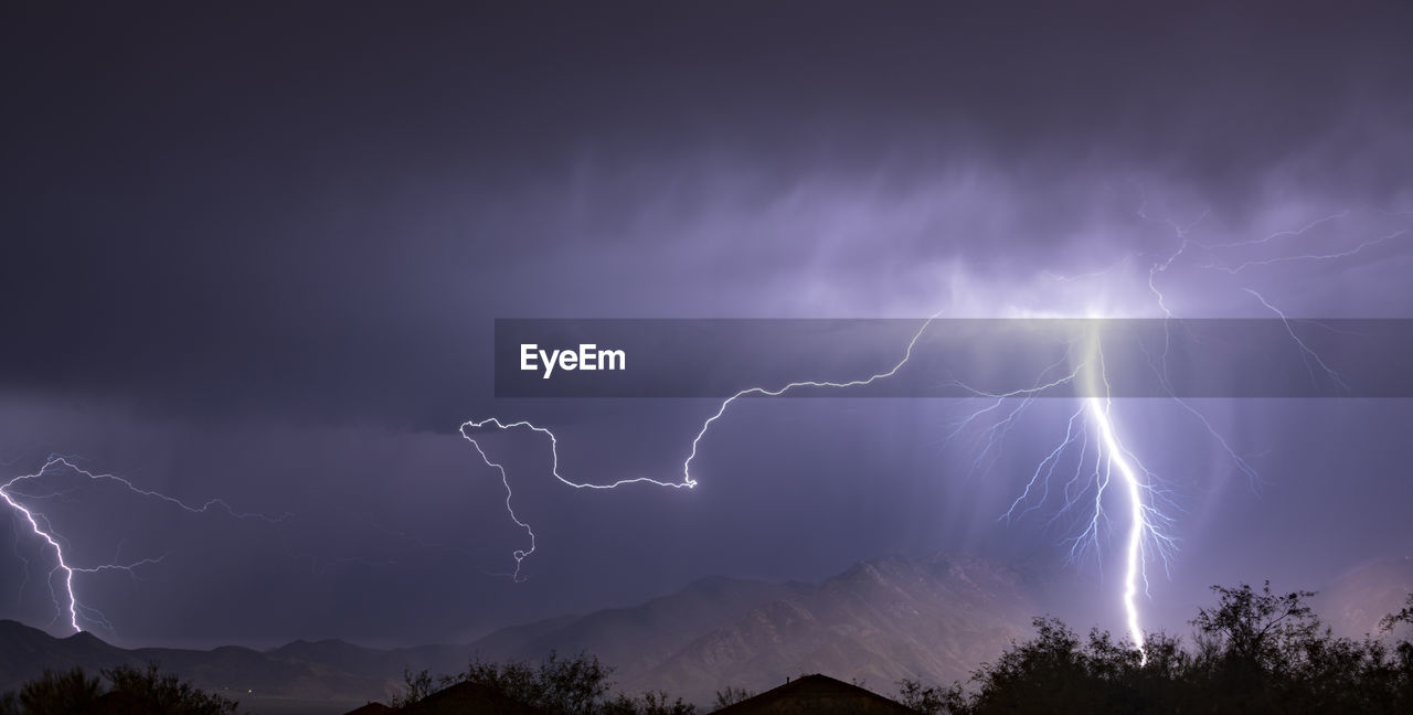 LOW ANGLE VIEW OF LIGHTNING AGAINST SKY