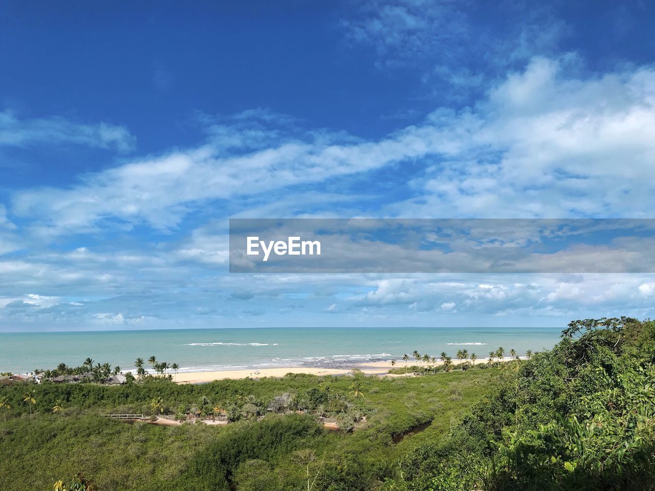 SCENIC VIEW OF BEACH AGAINST BLUE SKY