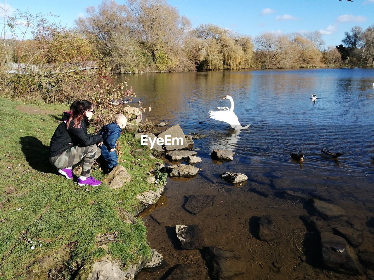 Mother with baby boy at lakeshore