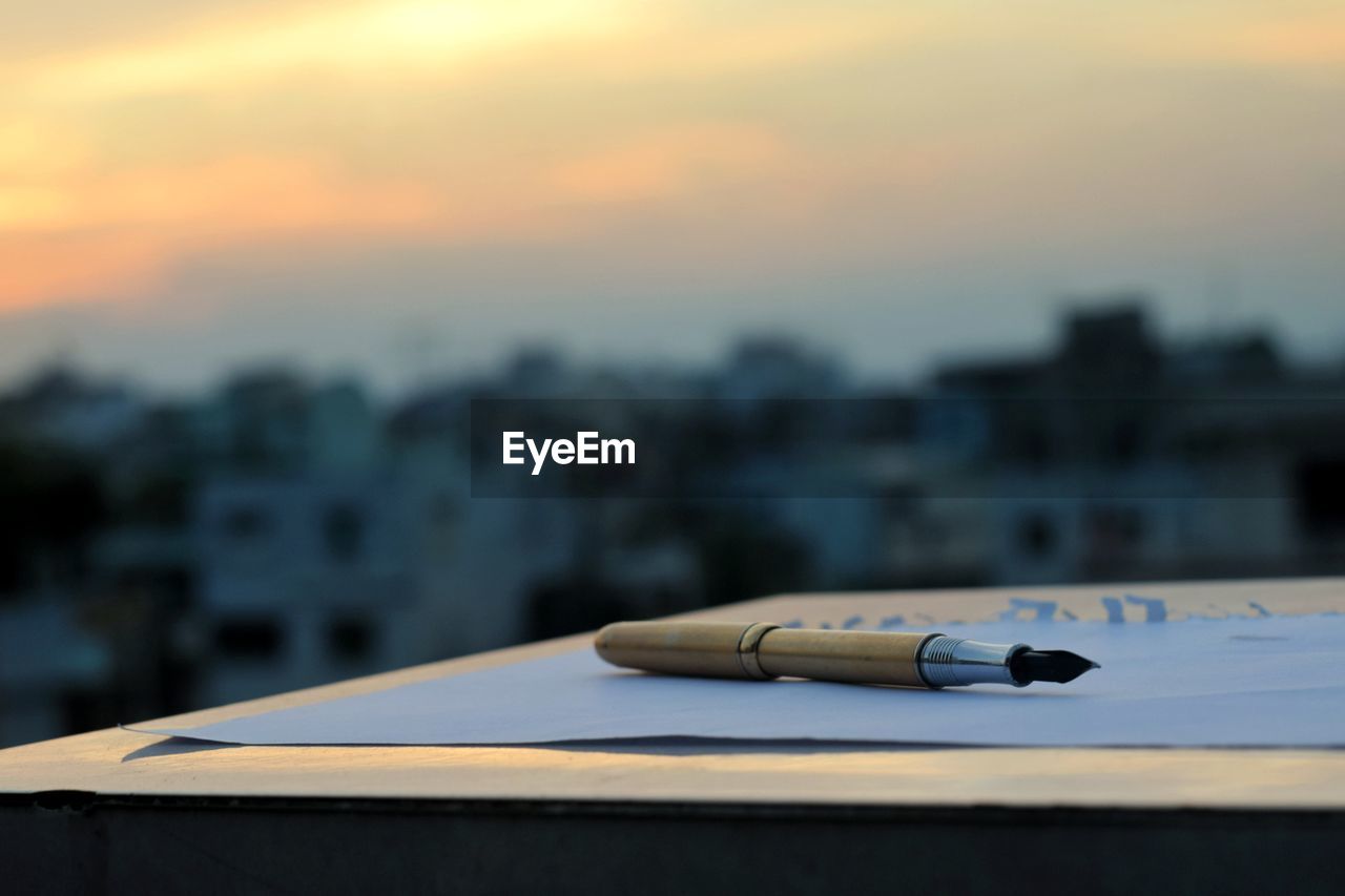 sky, architecture, blue, no people, focus on foreground, cloud, building exterior, sunset, nature, built structure, vehicle, city, reflection, aircraft, outdoors, close-up