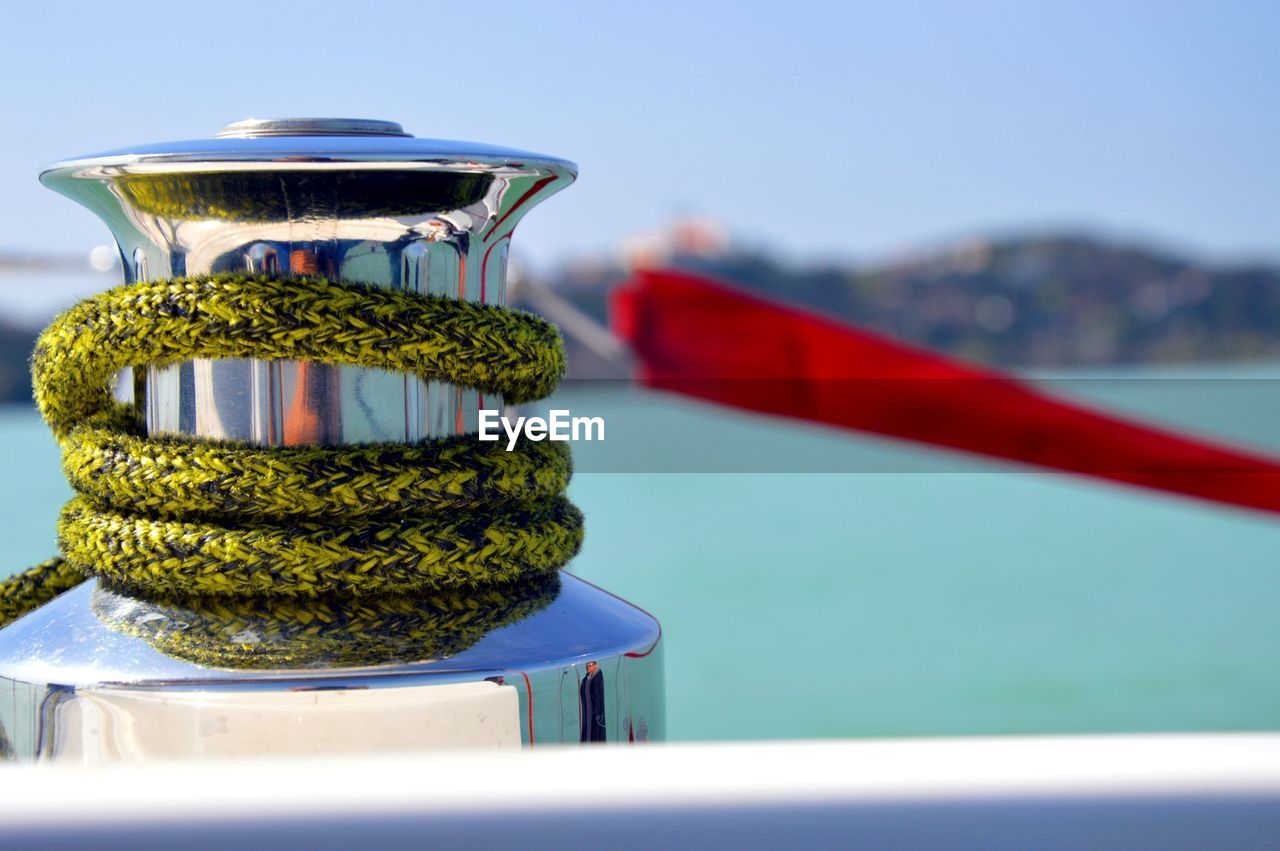 Close-up of rope handle on boat in sea