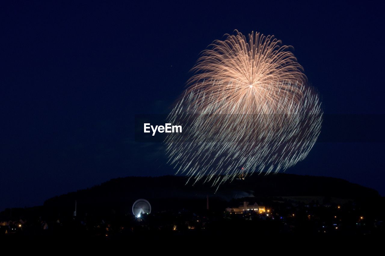 FIREWORK DISPLAY OVER CITY AT NIGHT