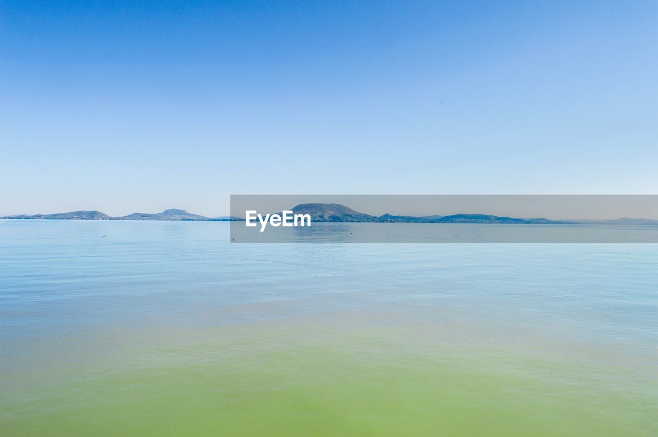 Scenic view of calm sea against clear sky