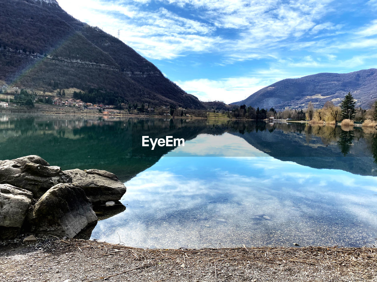 Scenic view of lake and mountains against sky