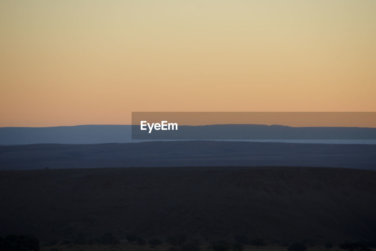 Scenic view of silhouette landscape against sky during sunset