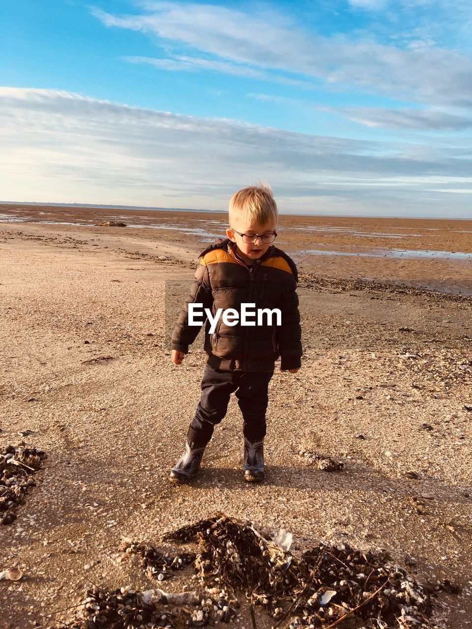 Full length of boy standing at beach