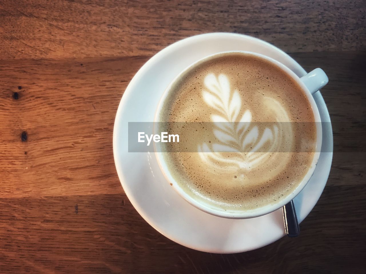 CLOSE-UP OF COFFEE CUP ON TABLE