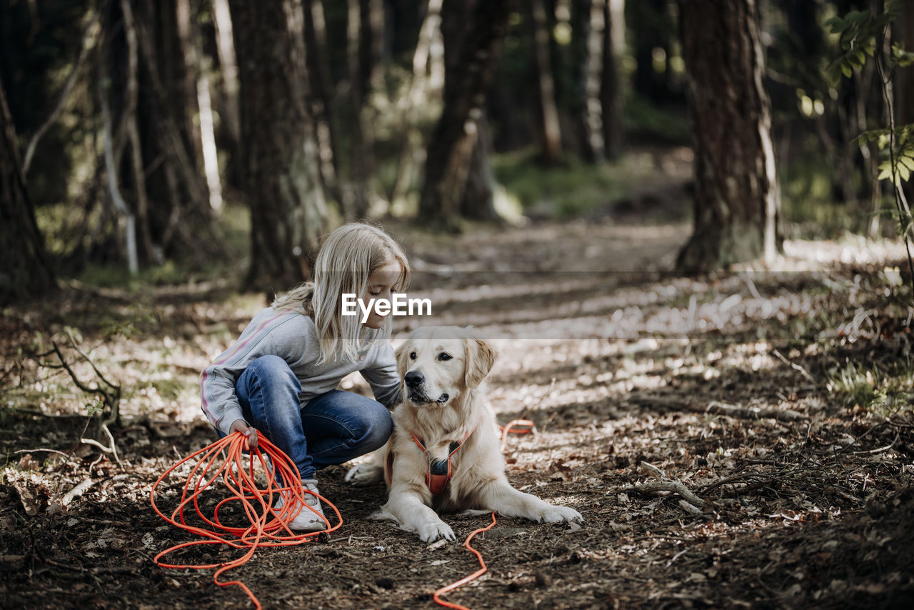 Girl with dog in forest