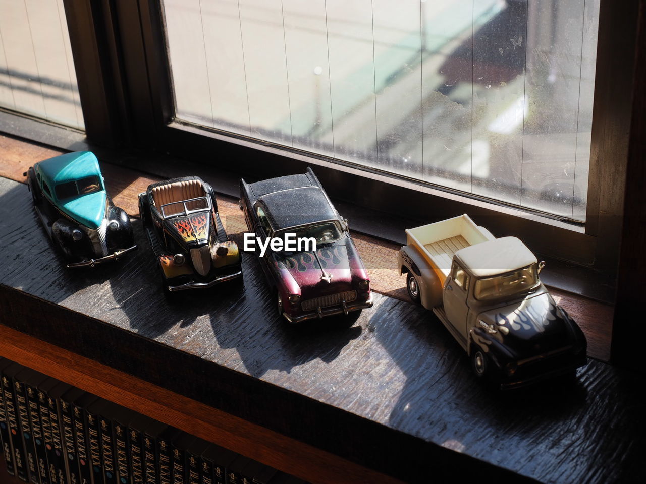 window, indoors, no people, table, transparent, glass - material, wood - material, communication, technology, connection, telephone, day, retro styled, still life, wireless technology, sunlight, group of objects, landline phone