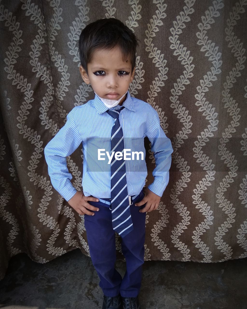 FULL LENGTH PORTRAIT OF CUTE BOY STANDING ON FLOOR