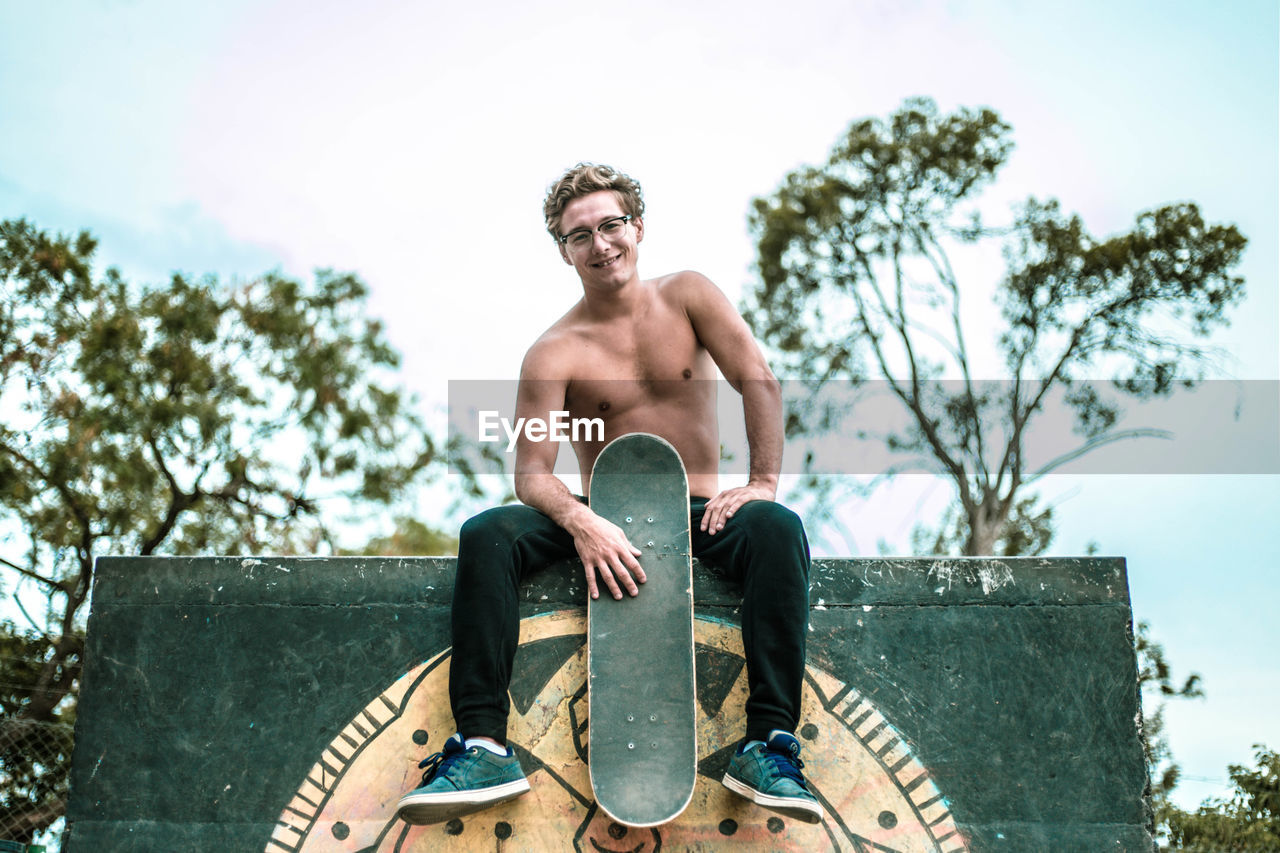 Shirtless happy skater