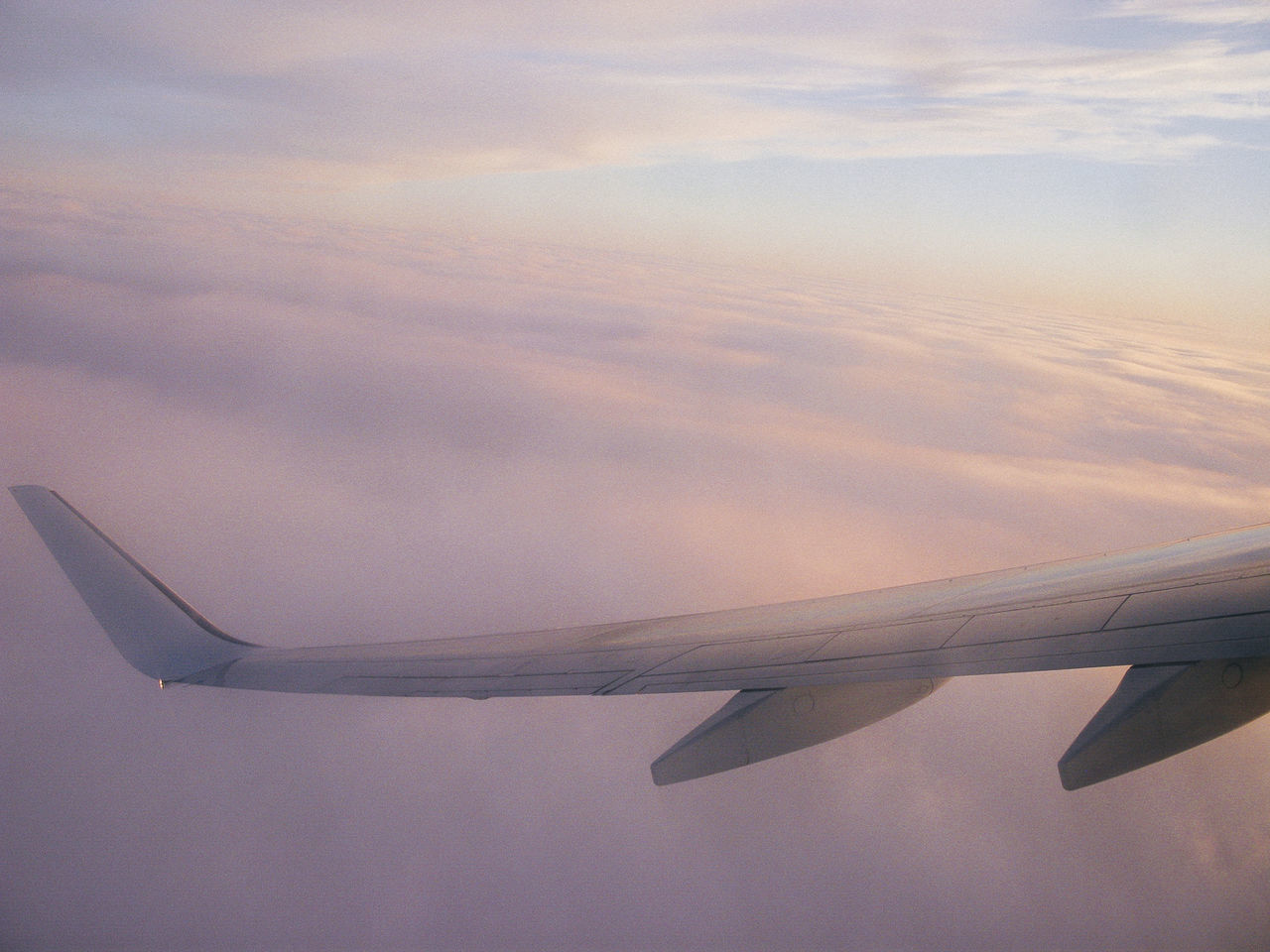 CLOSE-UP OF AIRCRAFT WING AGAINST SKY