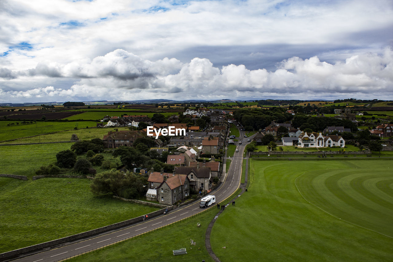 Houses on field against sky