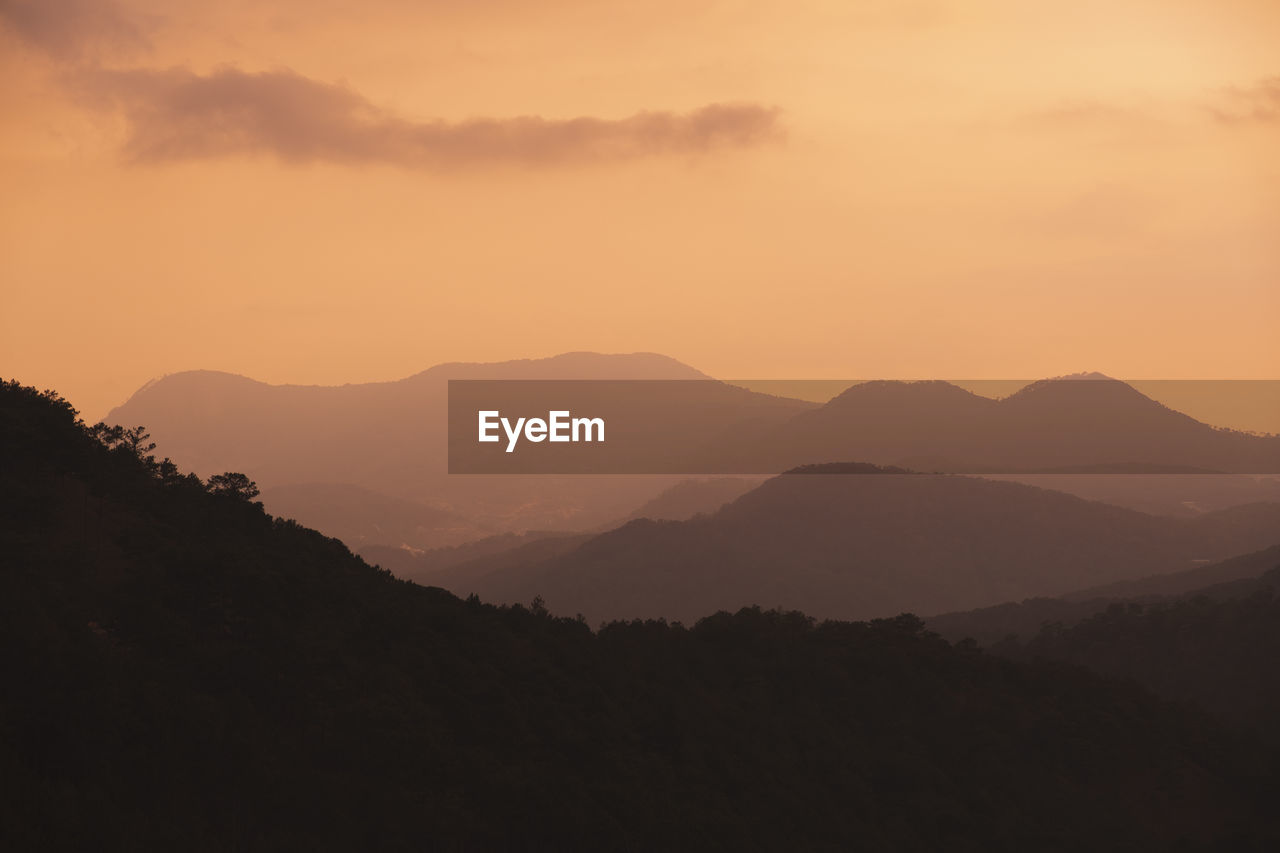 scenic view of silhouette mountains against sky during sunset