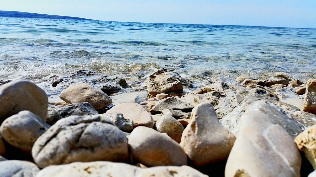 SCENIC VIEW OF SEA WITH ROCKS IN BACKGROUND