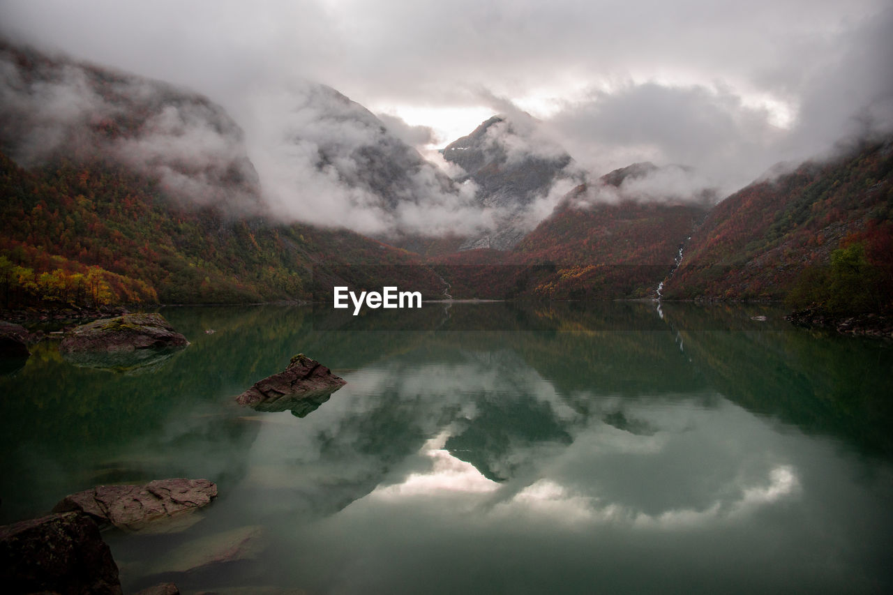 Scenic view of lake and mountains against sky