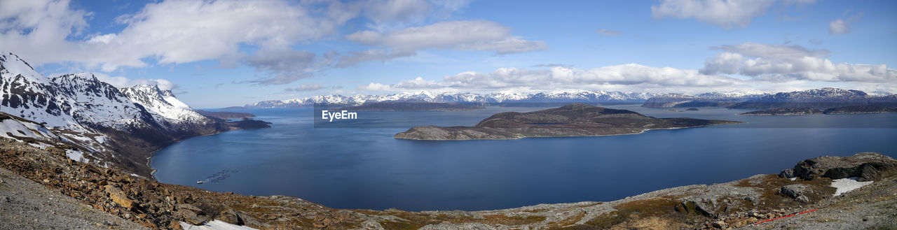 Panoramic view of sea and mountains against sky