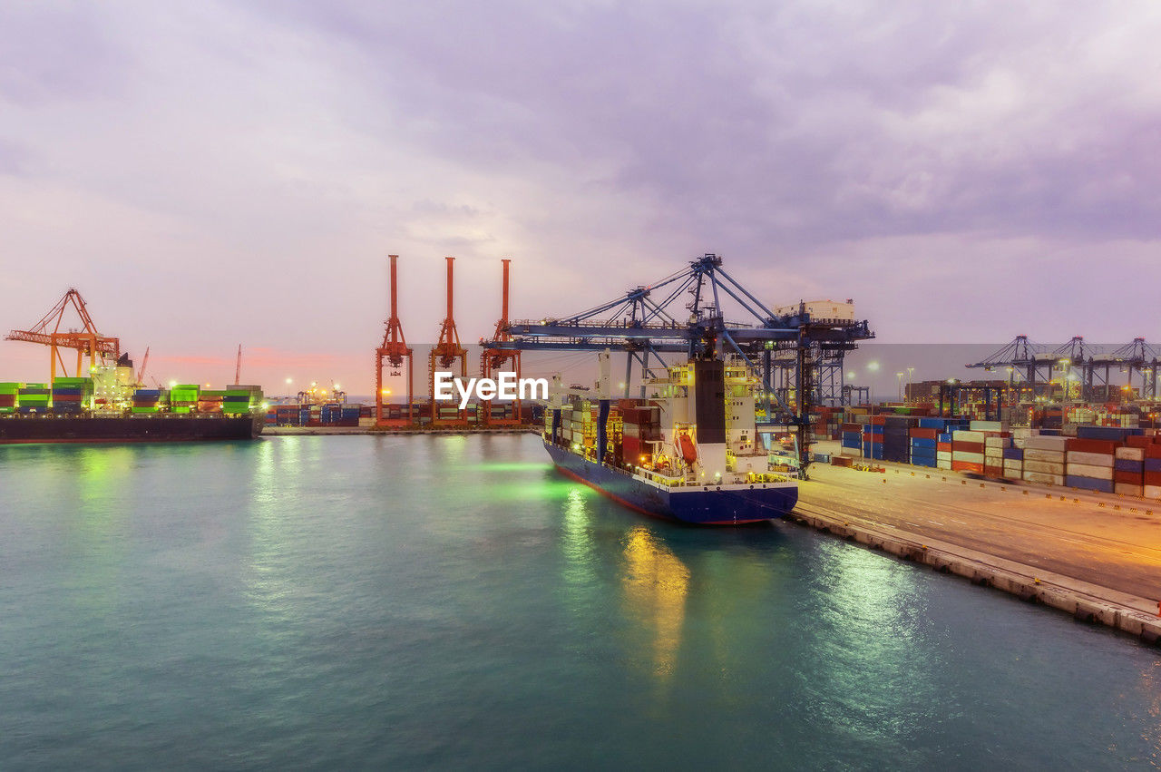 Container ships at illuminated dock