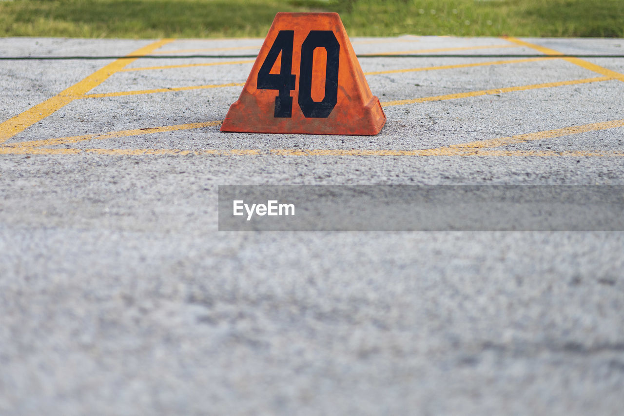 An orange forty yard line marker ready for a marching band rehearsal