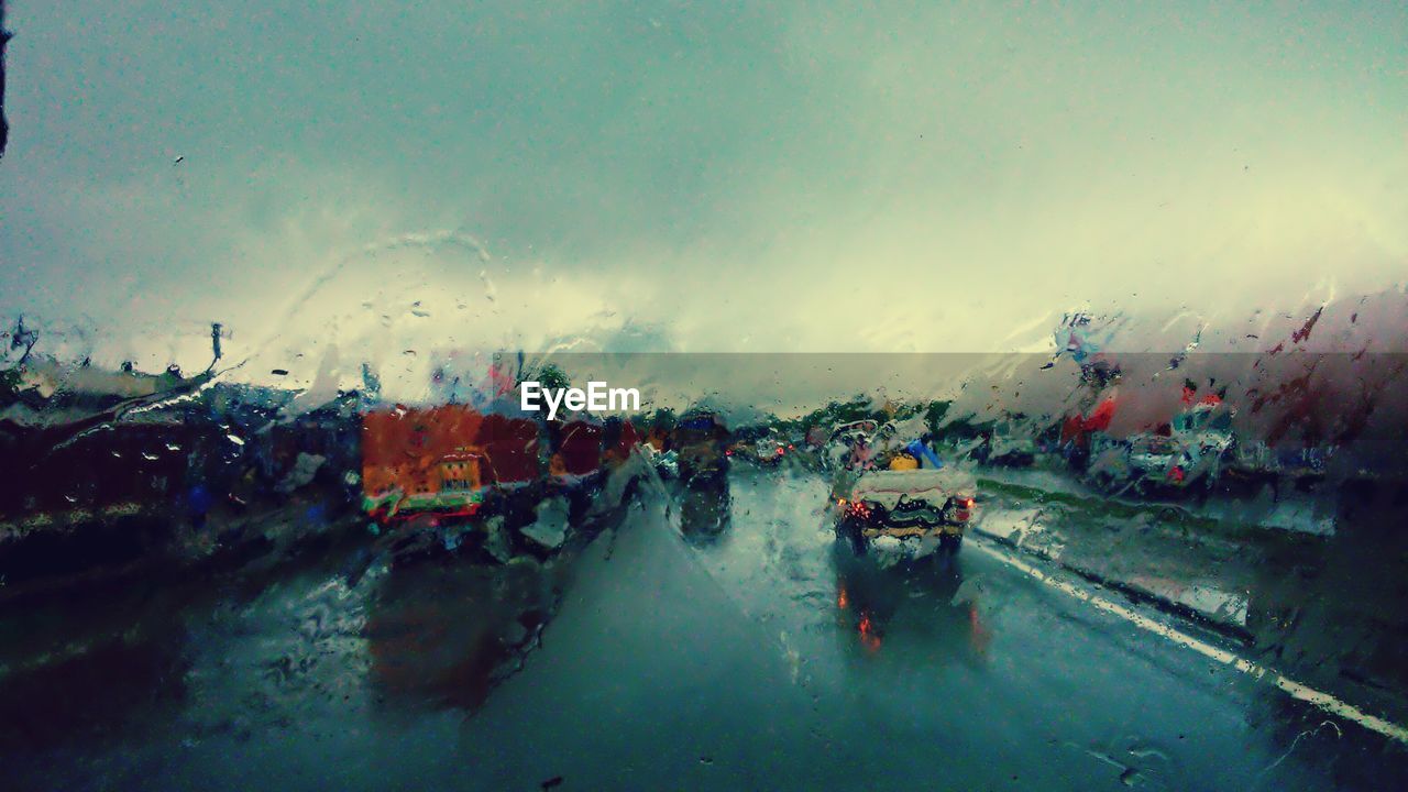 View of wet road against sky during sunset