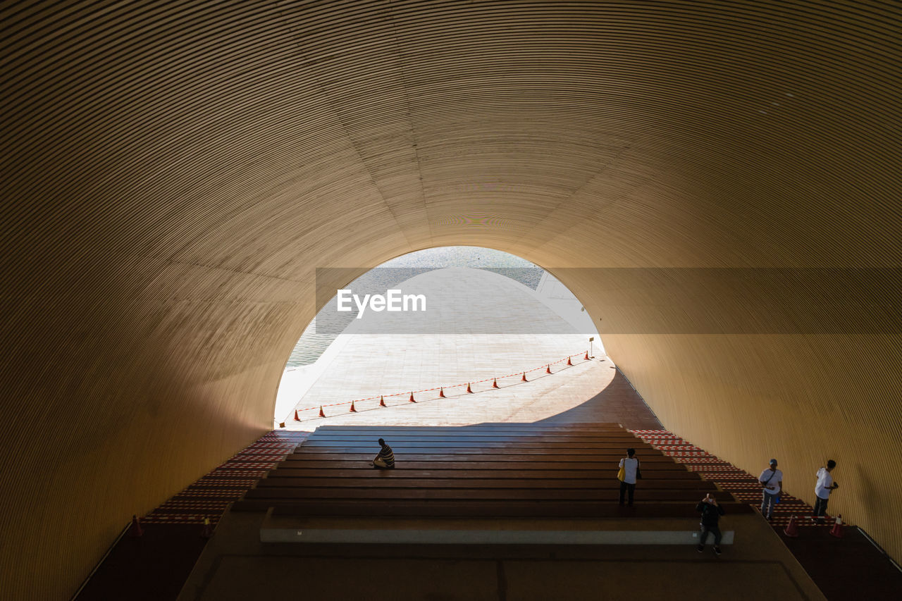 LOW ANGLE VIEW OF PEOPLE ON STAIRCASE