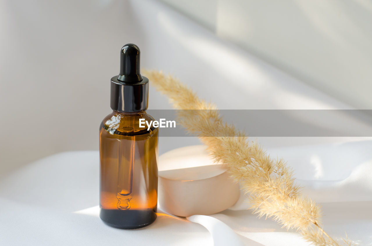 Essential oil or serum in a brown bottle with a dropper. cosmetics, body care.