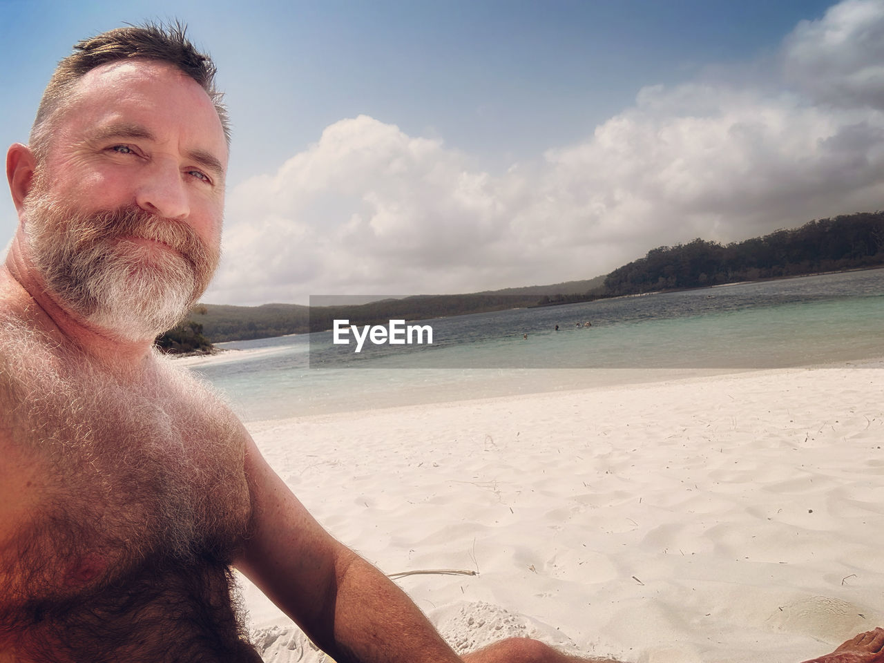 beach, land, water, sea, sky, adult, one person, men, holiday, sand, trip, vacation, nature, portrait, beard, facial hair, smiling, cloud, relaxation, happiness, looking at camera, mature adult, leisure activity, emotion, summer, travel, ocean, person, day, travel destinations, beauty in nature, sunlight, lifestyles, cheerful, outdoors, human face, shore, enjoyment, scenics - nature