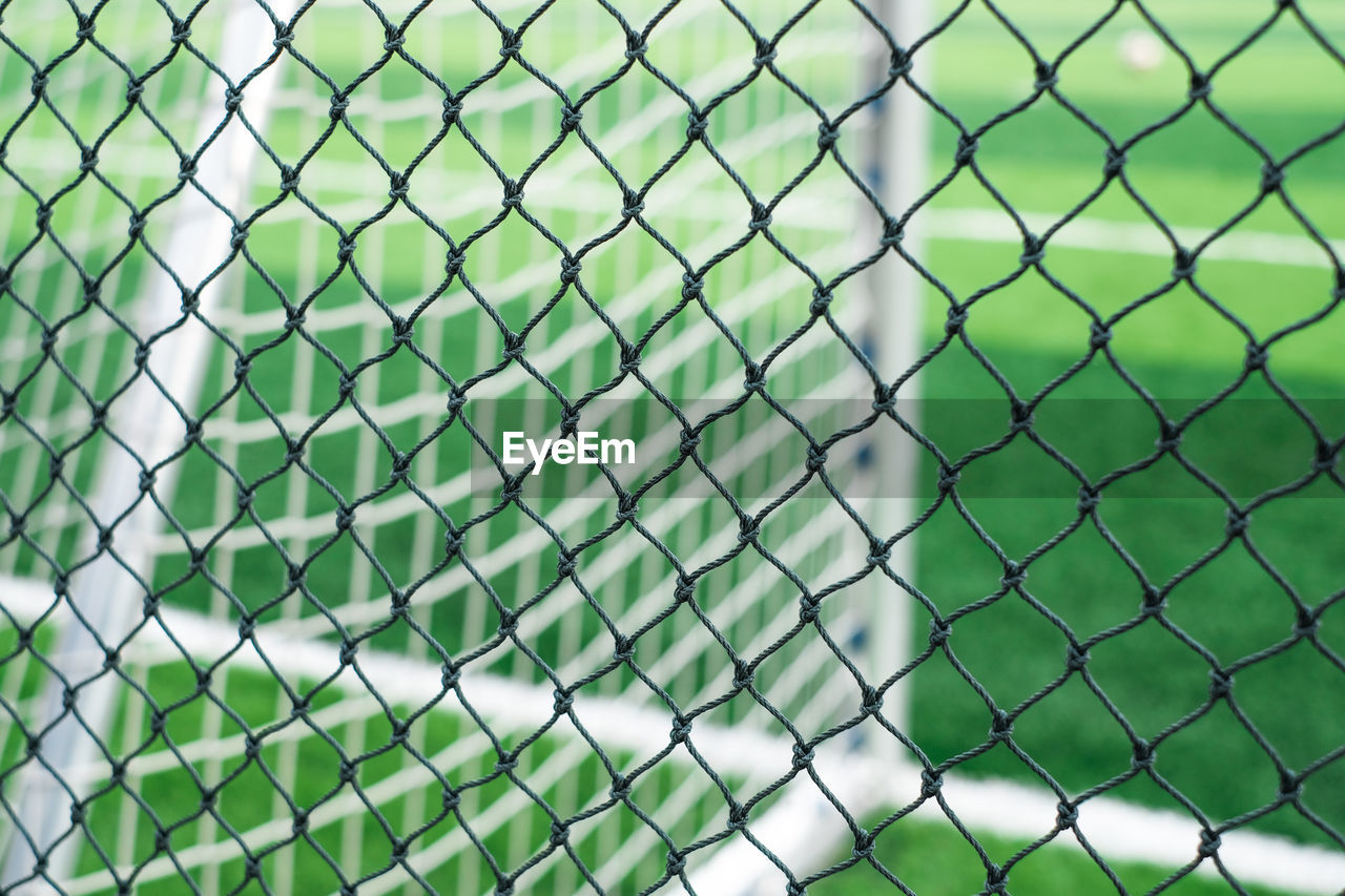 Full frame shot of chainlink fence in playing field