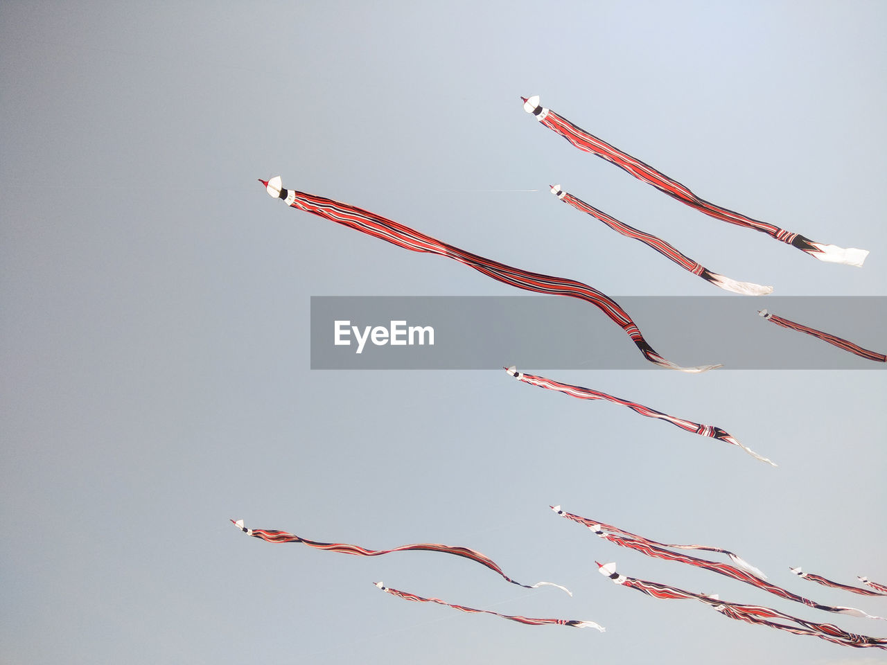 Low angle view of airplanes flying against clear sky