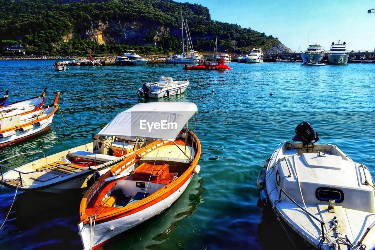 BOATS MOORED IN SEA