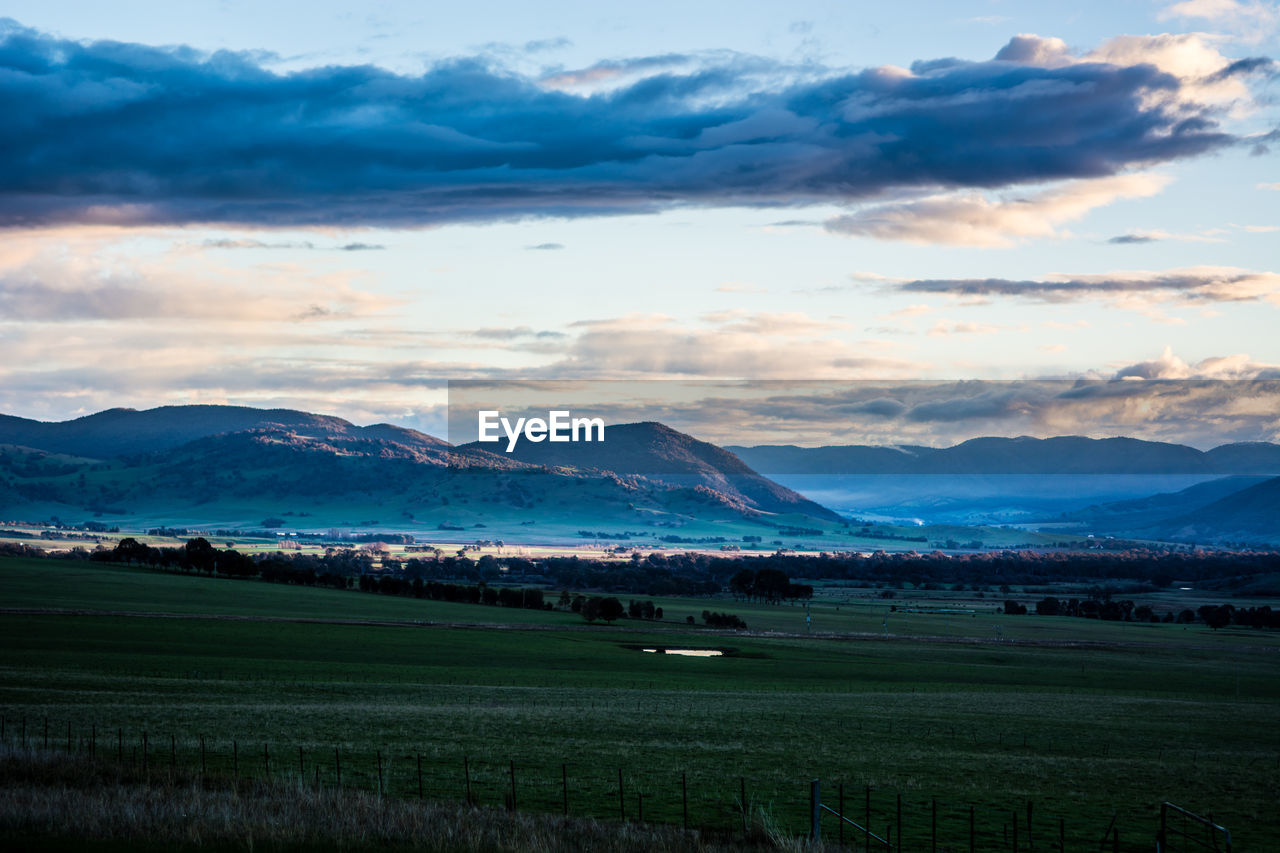 Scenic view of agricultural field against sky