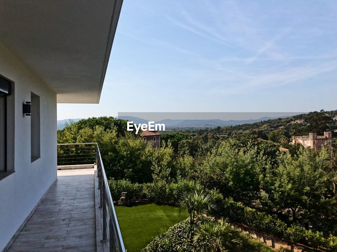 House amidst trees against sky