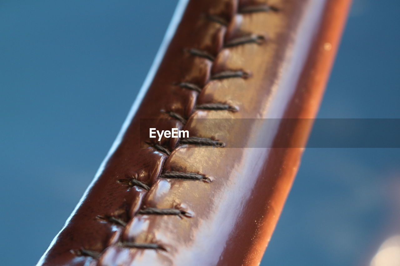 CLOSE-UP OF METAL AGAINST BLUE SKY