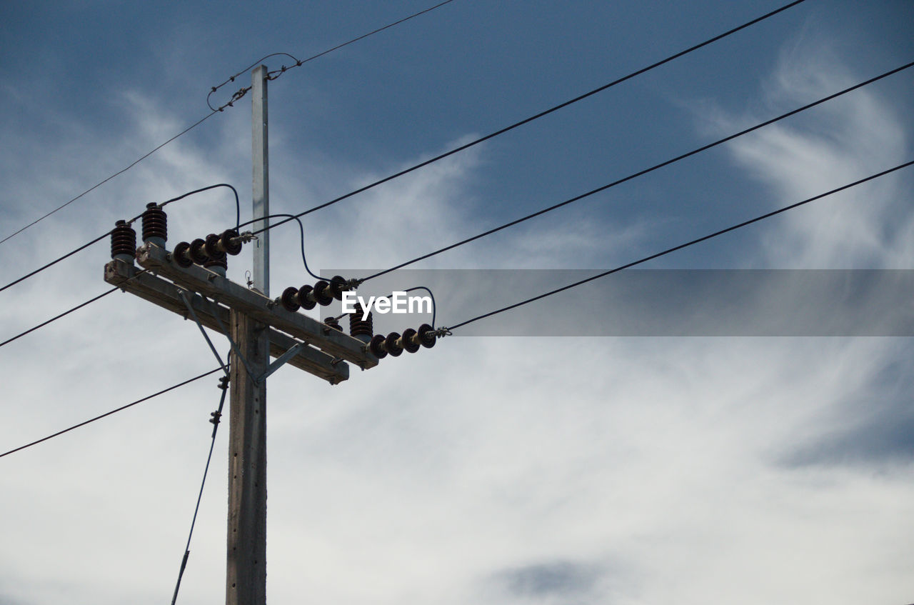 Low angle view of electricity pylon against sky