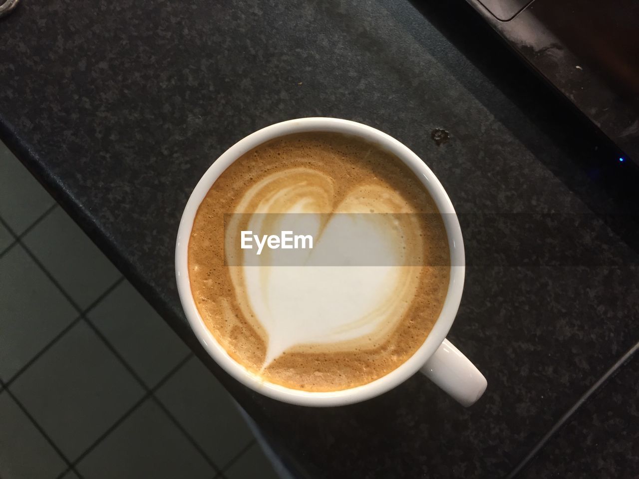 CLOSE-UP OF CAPPUCCINO ON TABLE