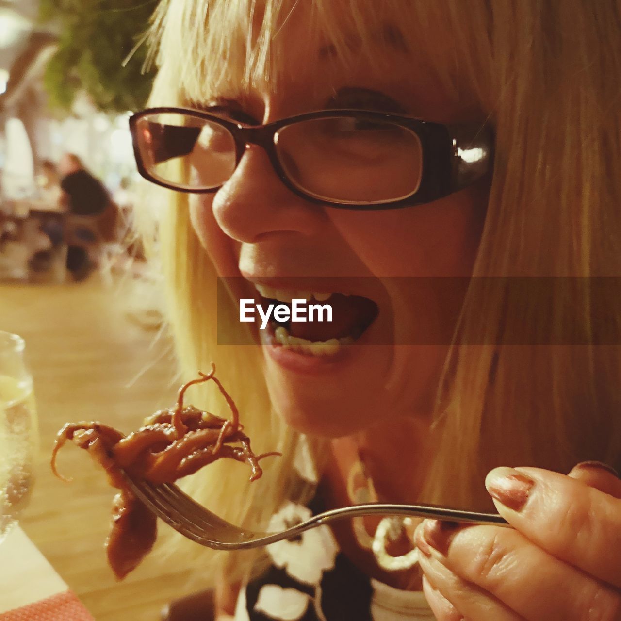 Close-up portrait of woman eating meal