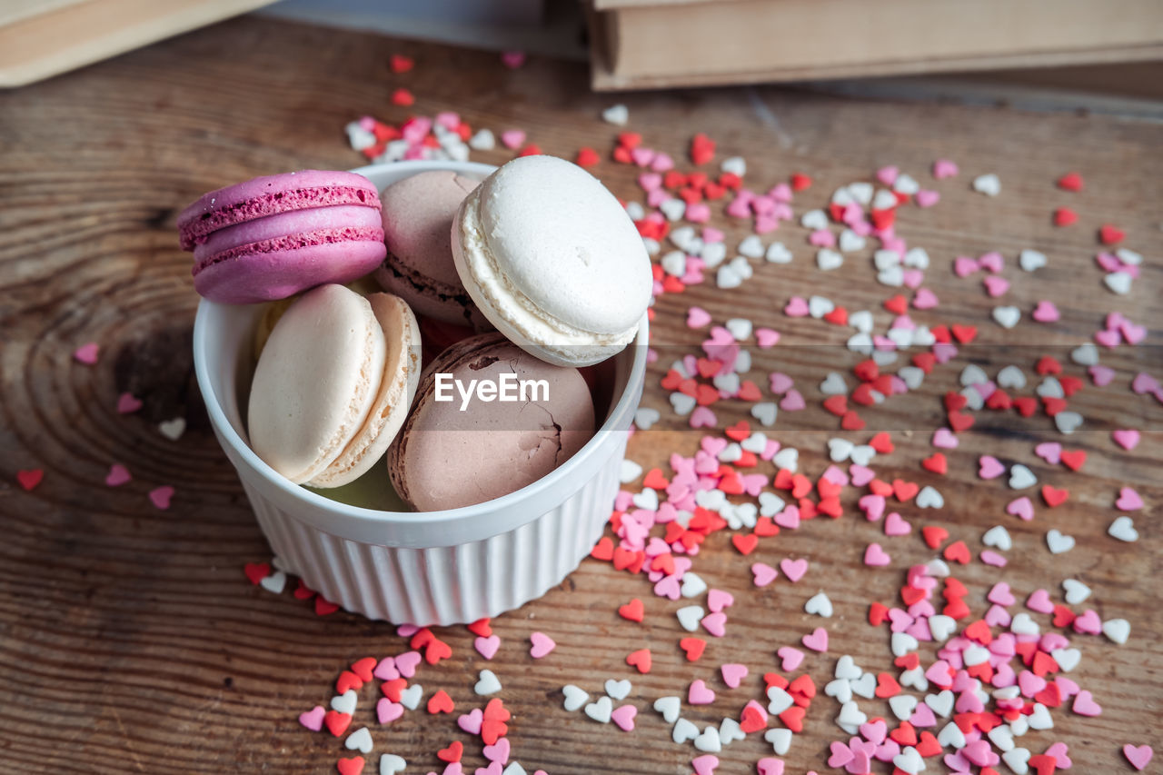 food and drink, pink, dessert, food, sweet food, sweet, wood, icing, freshness, indoors, no people, still life, high angle view, table, flower, sweetness, baked, chocolate, celebration, multi colored, close-up, petal