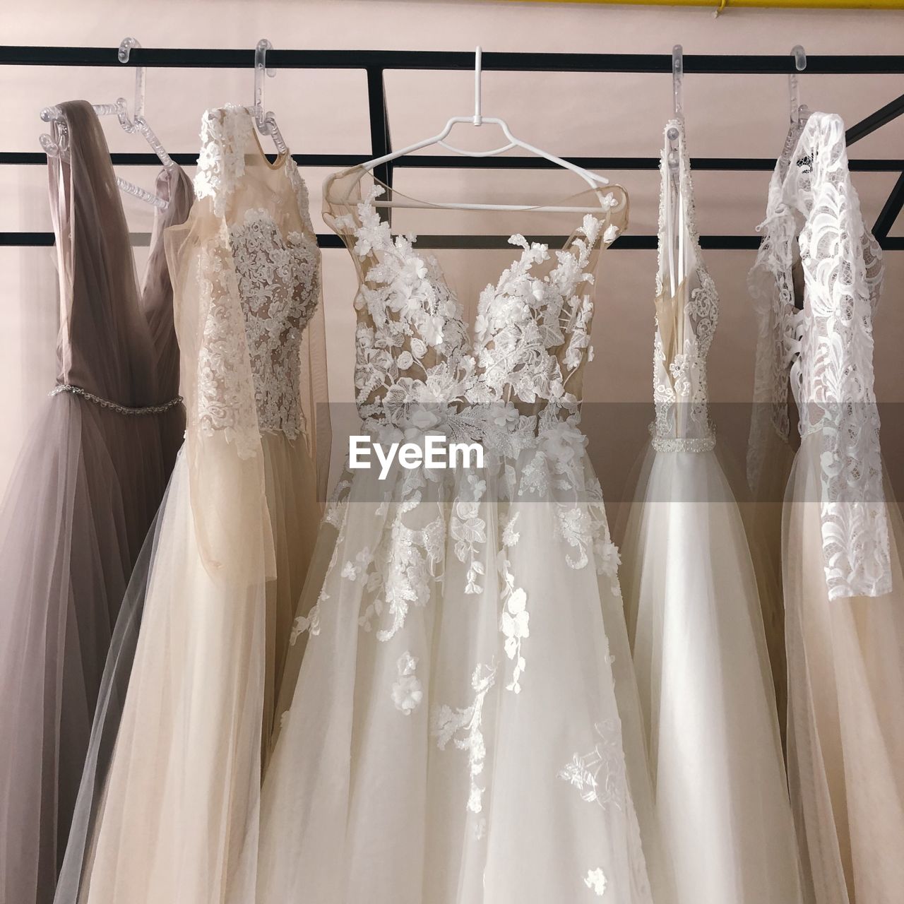 Wedding dresses hanging on rack in store