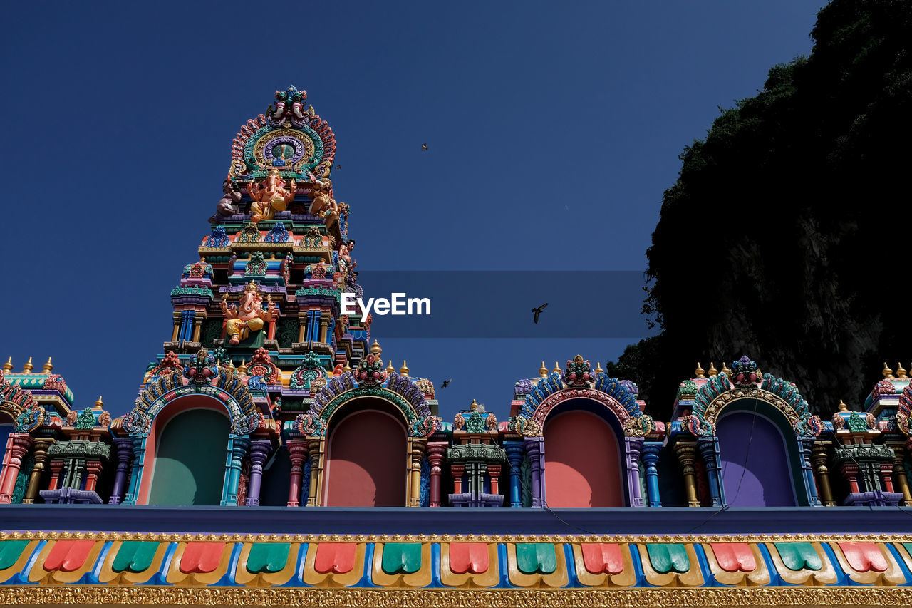 LOW ANGLE VIEW OF TEMPLE AGAINST BUILDING