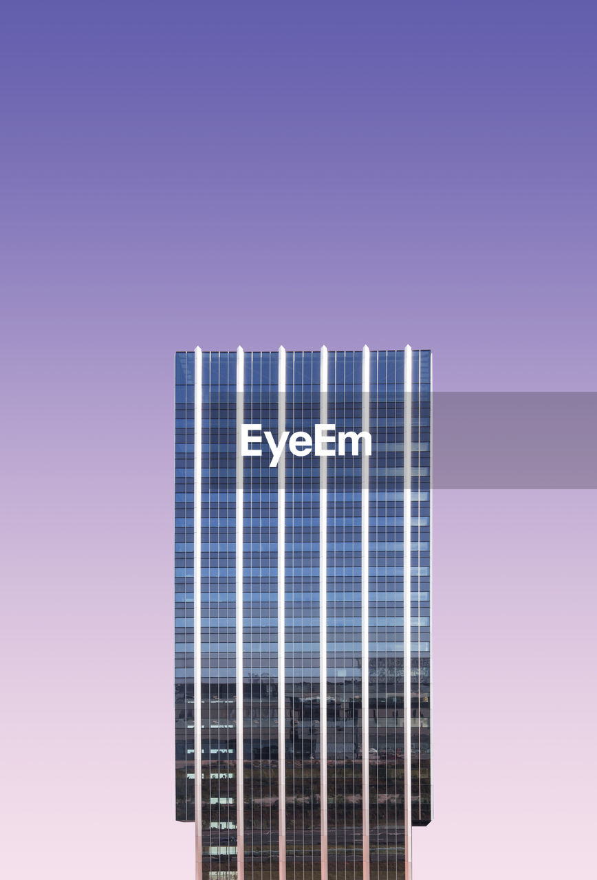 Digital composite image of modern building against colored background