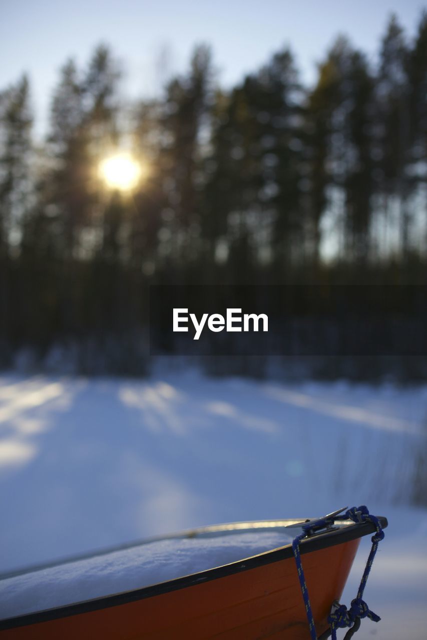 Side view of cropped wheelbarrow on snowed land