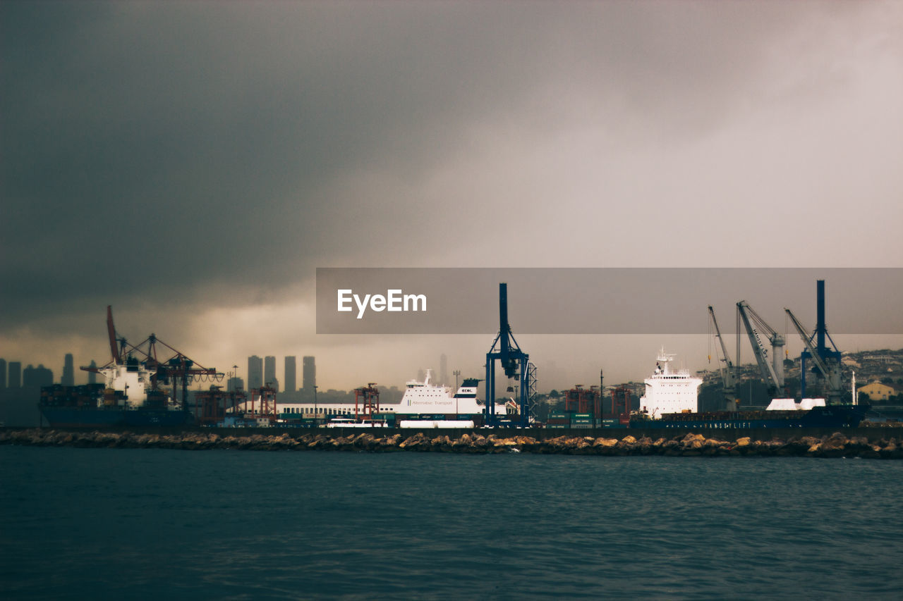 View of harbor against cloudy sky