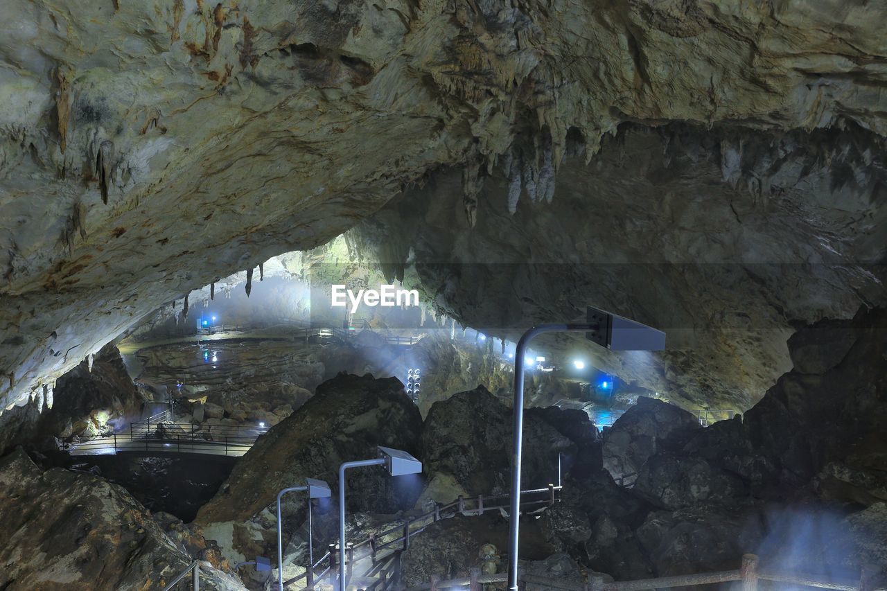 VIEW OF ILLUMINATED CANAL THROUGH CAVE