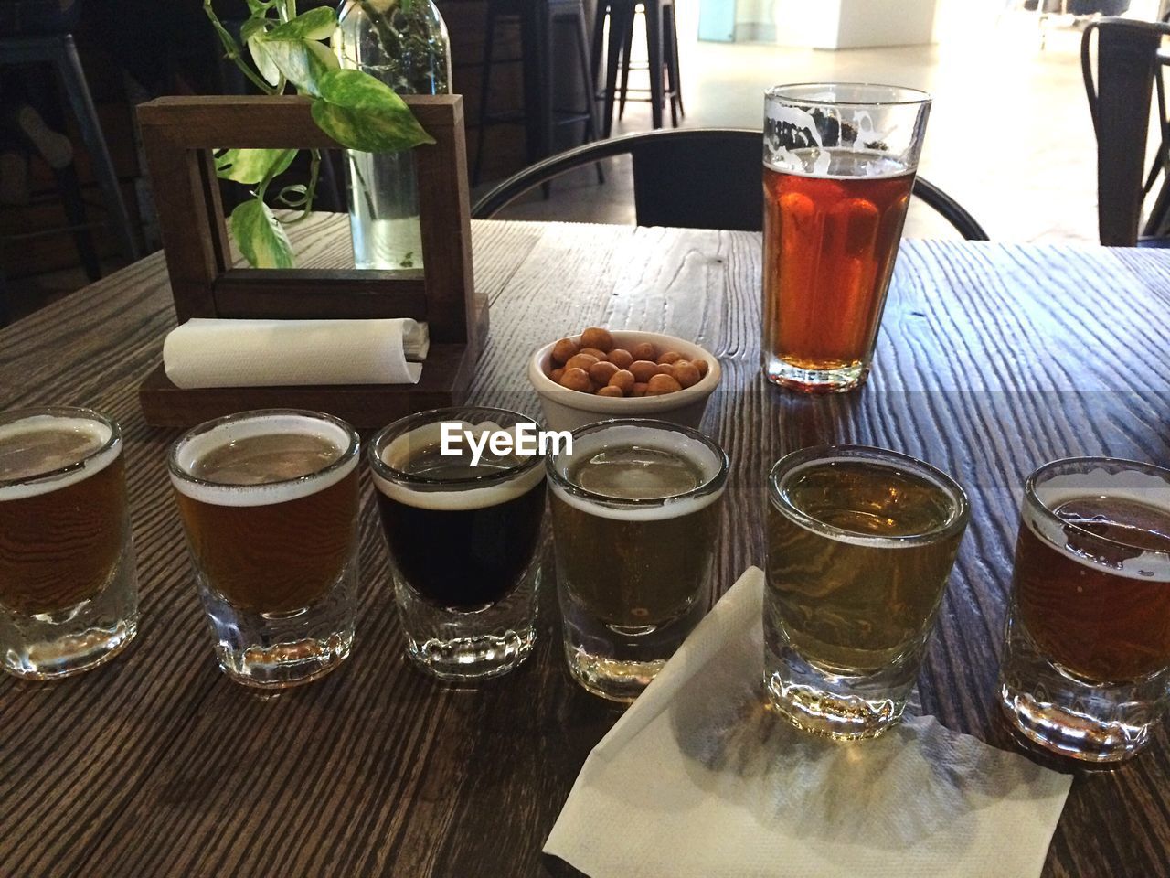 HIGH ANGLE VIEW OF BEER ON TABLE