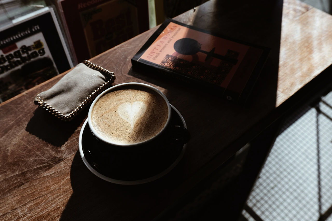 drink, food and drink, coffee, table, refreshment, mug, cup, coffee cup, still life, indoors, high angle view, no people, freshness, black, hot drink, frothy drink, wood, cafe, cappuccino, food
