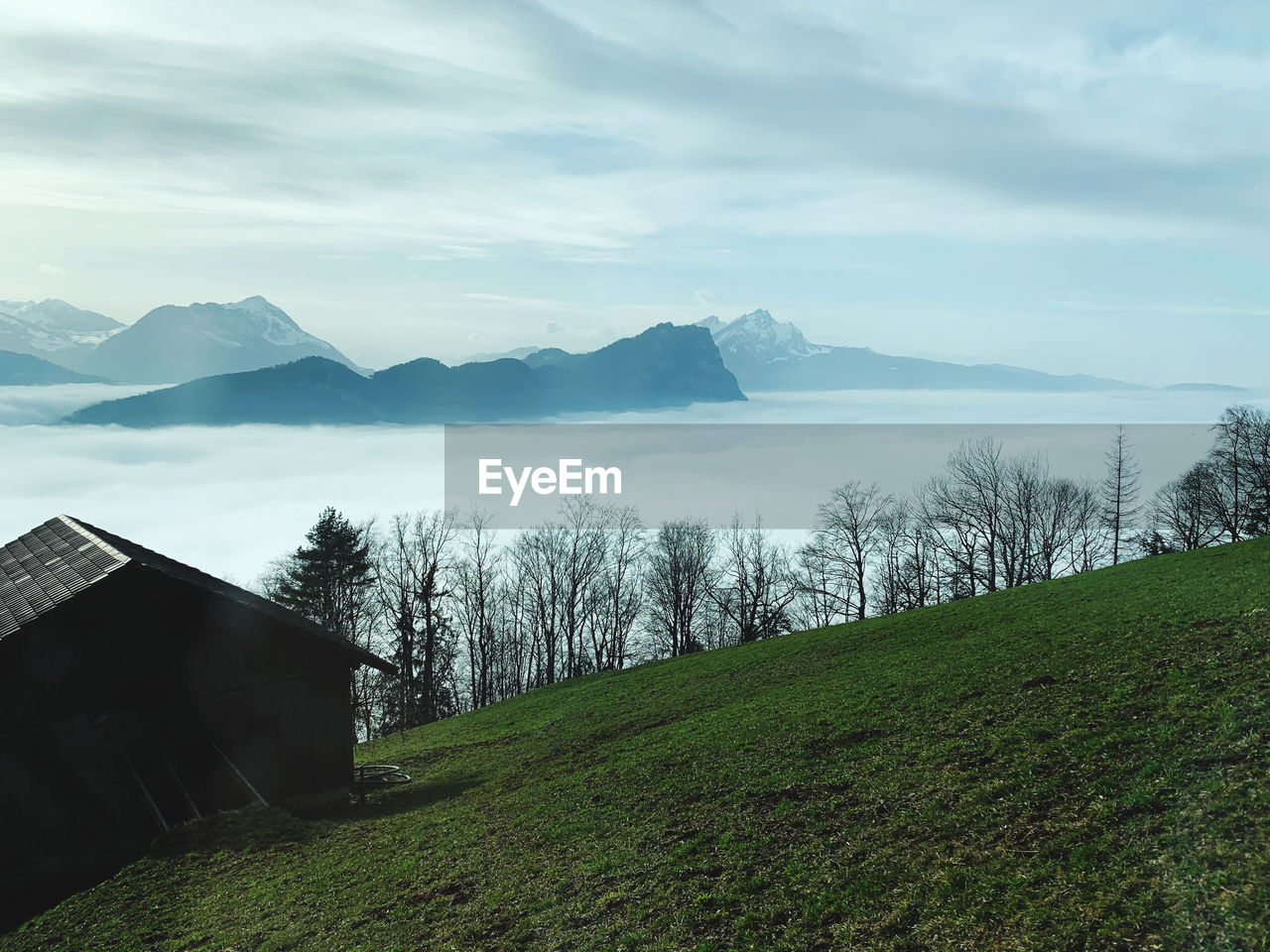 Scenic view of land and mountains against sky