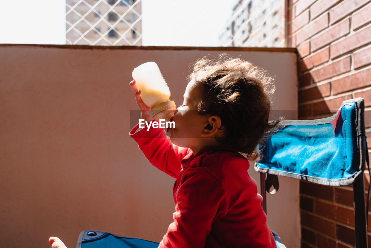 Boy holding bottle 