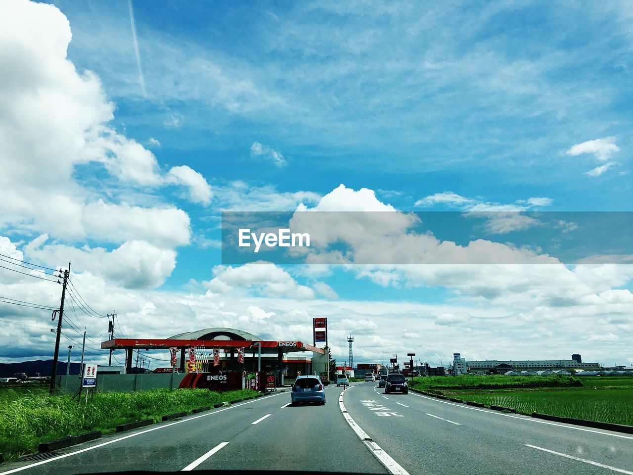 VIEW OF ROAD AGAINST CLOUDY SKY