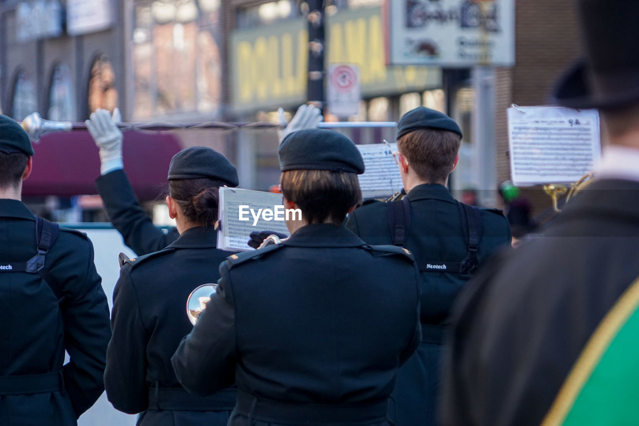 Rear view of army soldiers on street