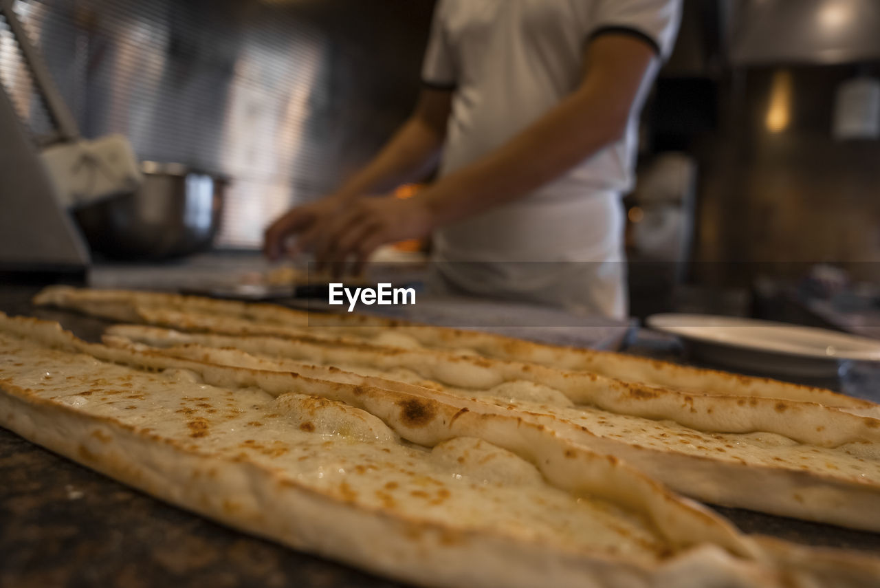 Close-up of fresh turkish cheese pide on counter at restaurant